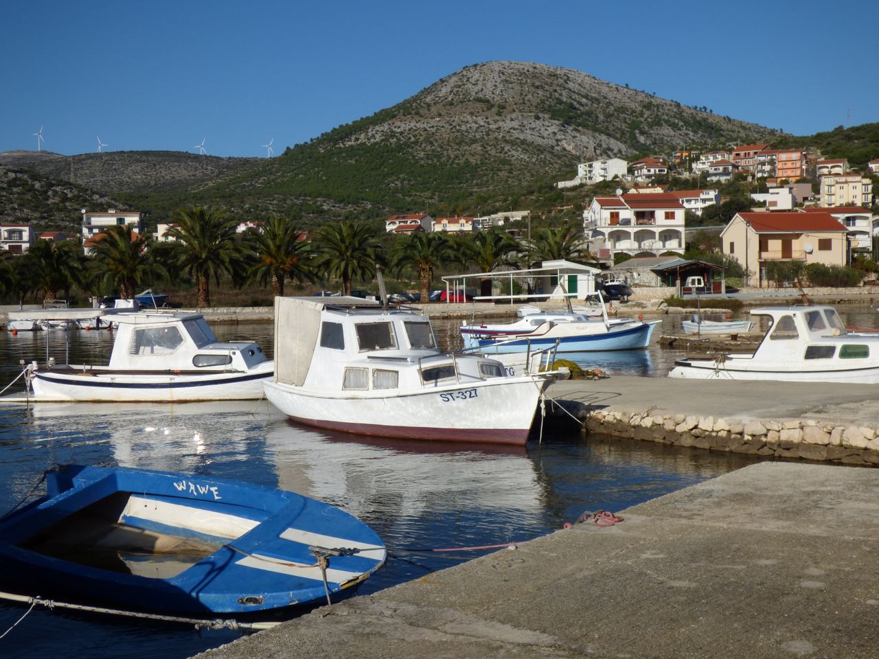 Quaint boats nestled in Grebaštica harbor with scenic coastal views.